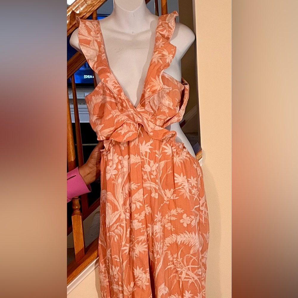 Salmon pink with white accents v-neck jumpsuit with tie back.